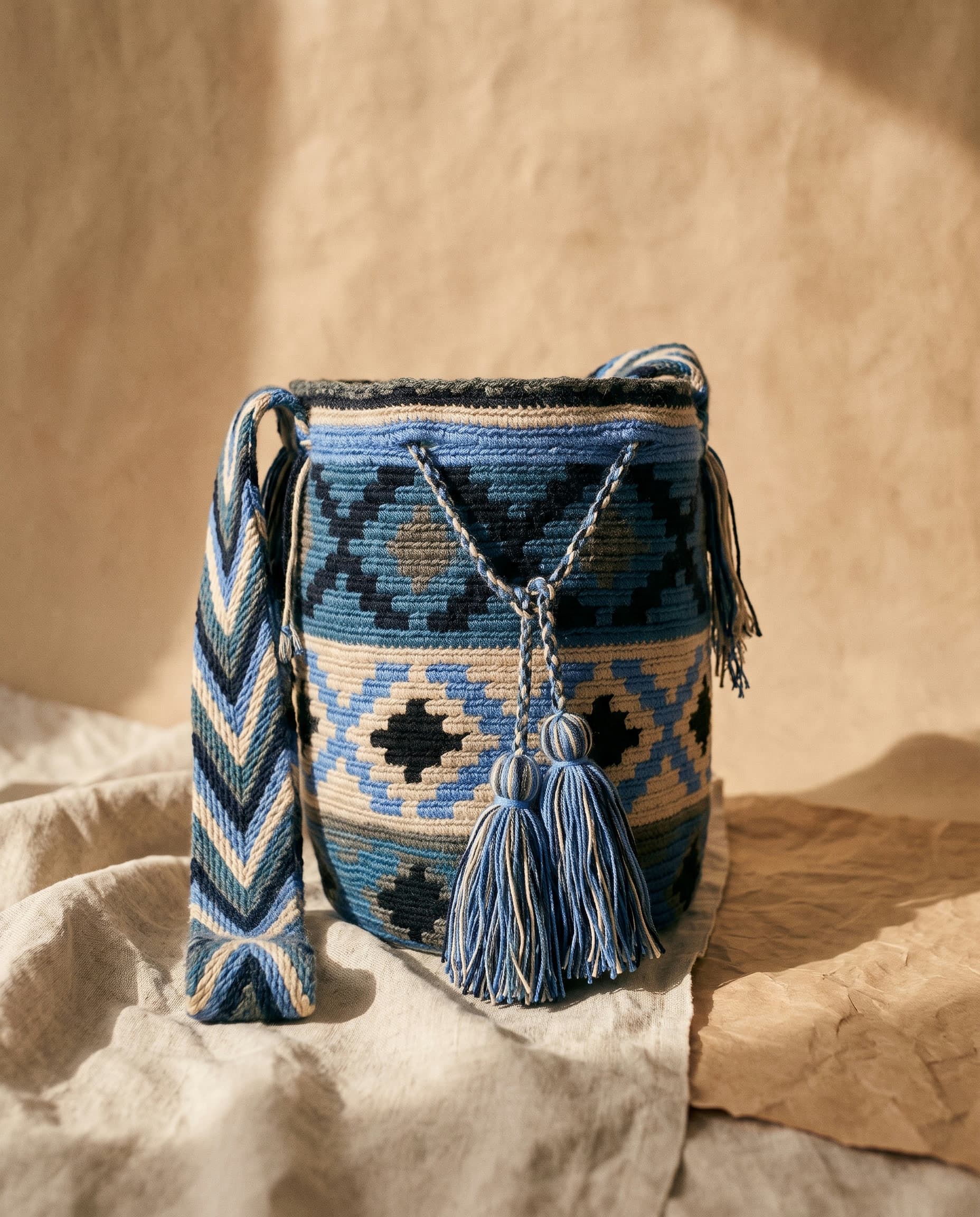Handgewebte Wayuu-Mochila mit geometrischem Kaana-Muster in Indigo und Sand